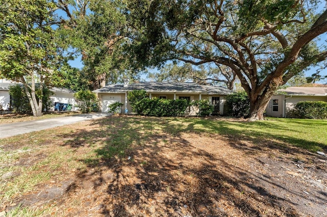 ranch-style house featuring a front lawn and a garage