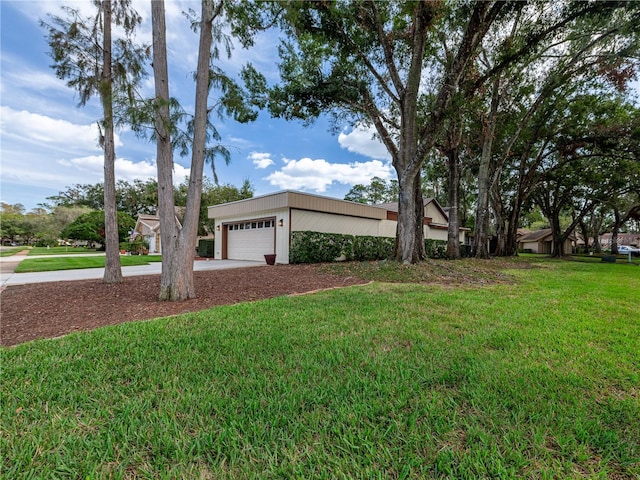 single story home featuring a front lawn and a garage