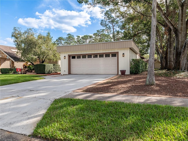 view of front of property with a garage and a front lawn