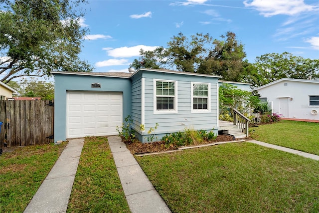 view of front of property featuring a garage and a front lawn