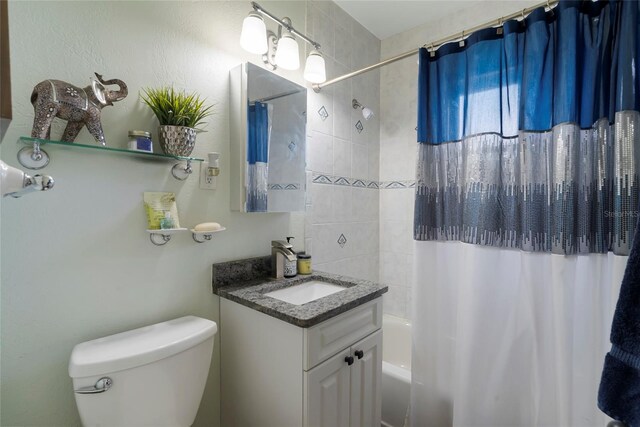 full bathroom with shower / bath combo, vanity, and toilet