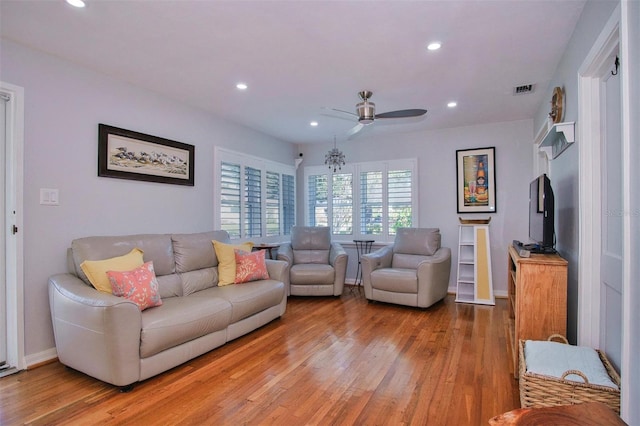 living room featuring ceiling fan and light wood-type flooring