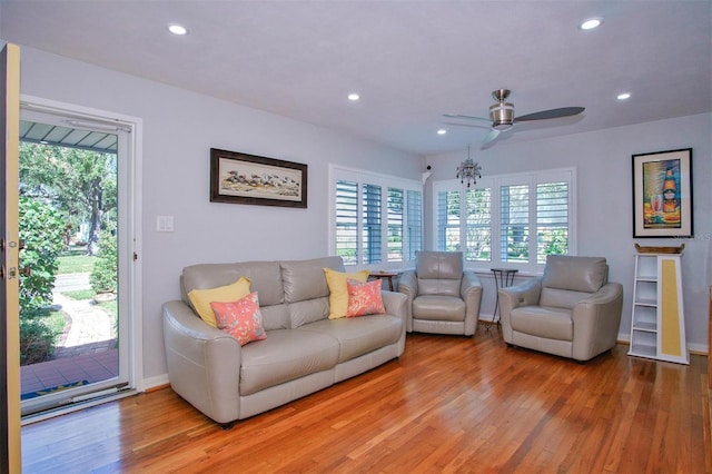 living room featuring ceiling fan and hardwood / wood-style floors