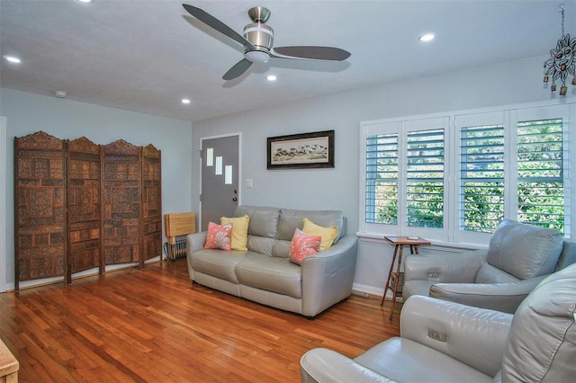 living room featuring ceiling fan and hardwood / wood-style floors