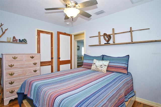 bedroom with ceiling fan and hardwood / wood-style floors