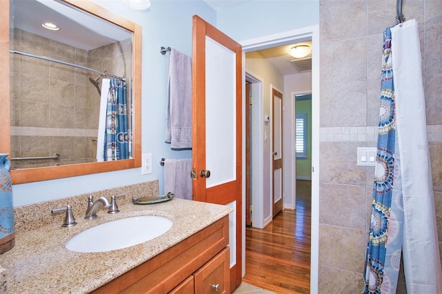 bathroom with vanity, wood-type flooring, and a shower with shower curtain