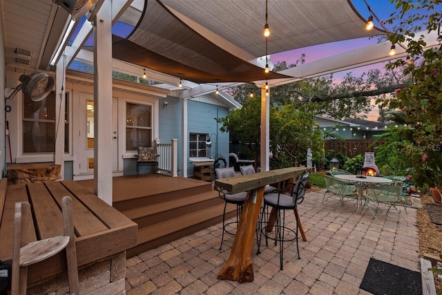 view of patio terrace at dusk