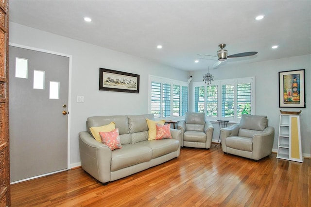 living room featuring ceiling fan and hardwood / wood-style flooring