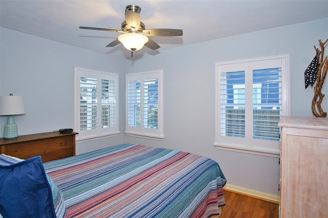 bedroom with dark wood-type flooring and ceiling fan