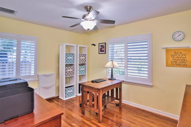 office space with hardwood / wood-style flooring, plenty of natural light, and ceiling fan