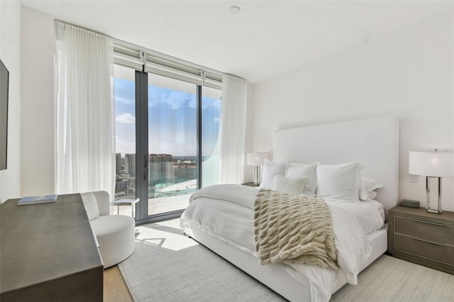 bedroom featuring multiple windows and light hardwood / wood-style floors