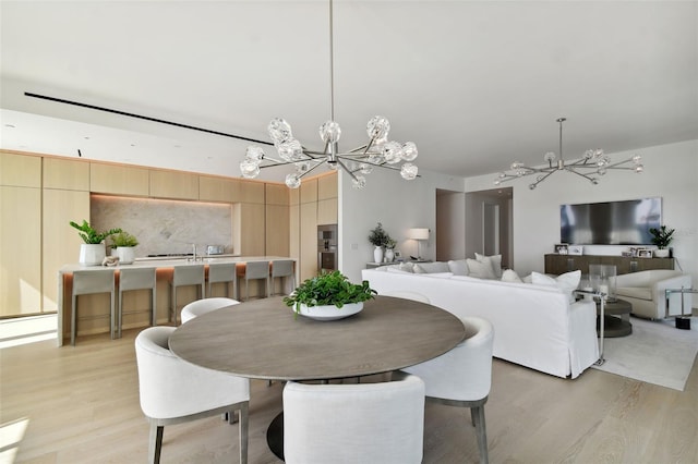 dining room featuring a chandelier and light wood-type flooring