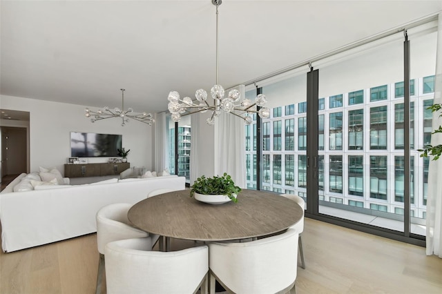 dining room featuring a notable chandelier and light hardwood / wood-style flooring