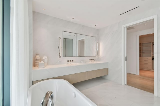 bathroom with vanity, wood-type flooring, and a bathing tub