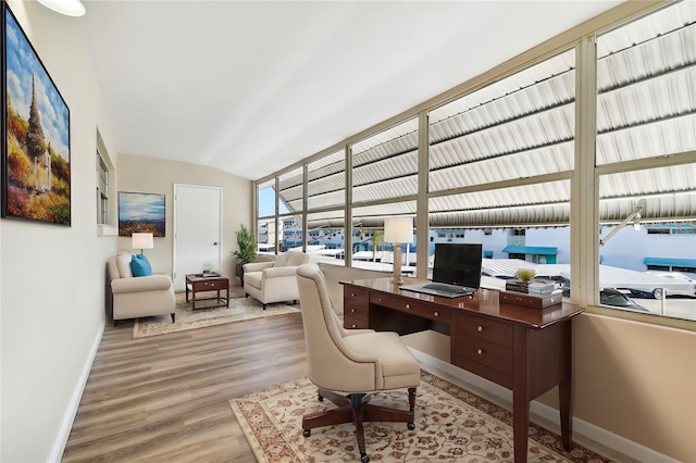 office featuring vaulted ceiling and hardwood / wood-style floors