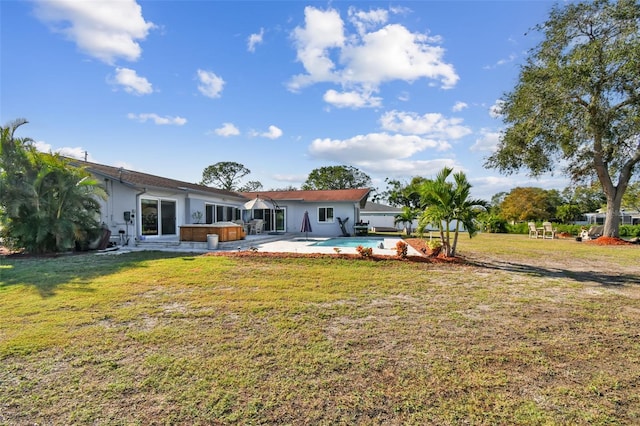 exterior space with a swimming pool with hot tub, a yard, and a patio