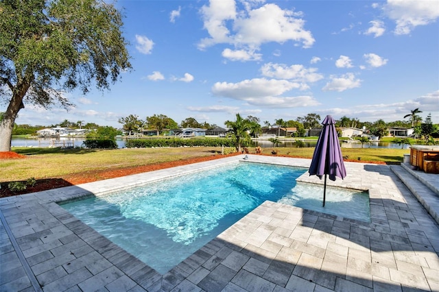 view of swimming pool with a water view, a lawn, and a patio area