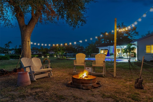 playground at night with a yard and a fire pit