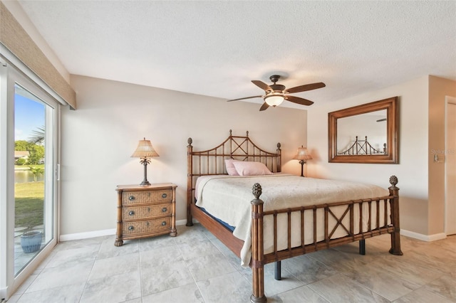 bedroom featuring a textured ceiling, ceiling fan, and access to outside