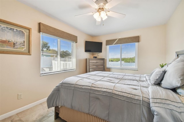 tiled bedroom featuring ceiling fan