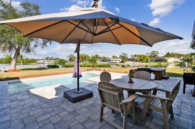 view of patio with a pool with hot tub and a water view