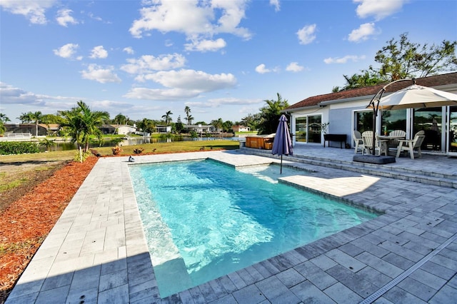 view of pool with a jacuzzi and a patio