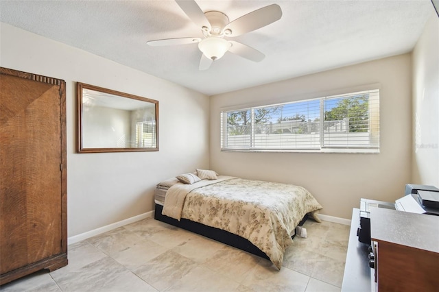 bedroom featuring ceiling fan and baseboards