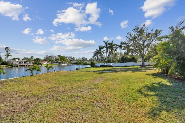 view of yard featuring a water view and fence