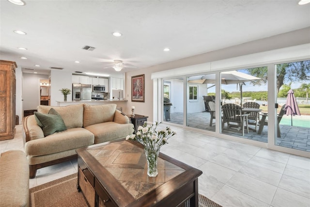 living room featuring light tile patterned floors, visible vents, and recessed lighting