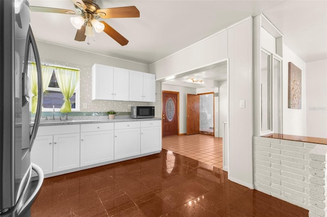 kitchen featuring tasteful backsplash, appliances with stainless steel finishes, sink, and white cabinets