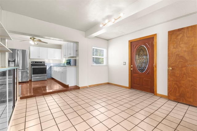 tiled foyer featuring beamed ceiling, ceiling fan, and sink