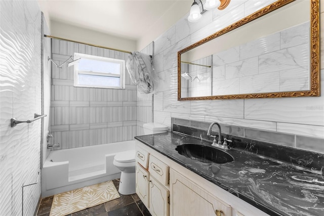 full bathroom with tile walls, vanity, toilet, and tiled shower / bath