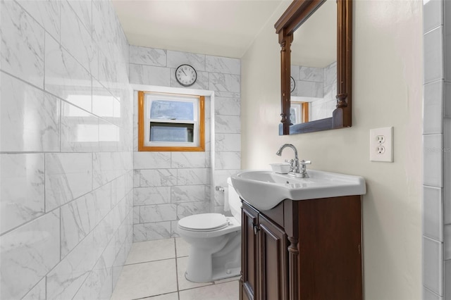 bathroom featuring tile patterned flooring, vanity, toilet, and tile walls