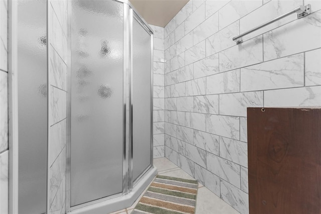 bathroom with a shower with door