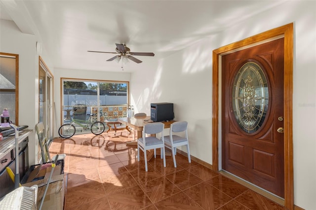 tiled foyer entrance with ceiling fan