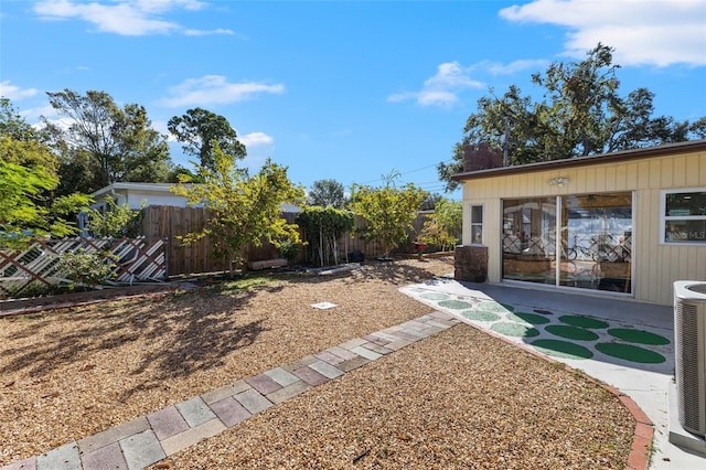 view of yard featuring cooling unit and a patio