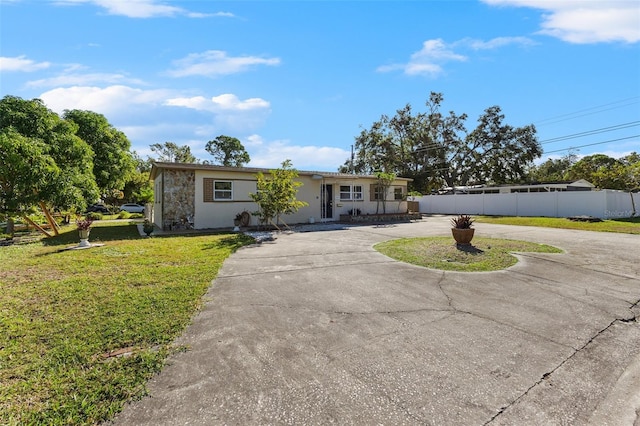 single story home with a front yard and covered porch