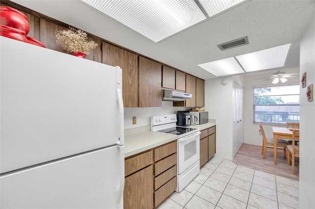 kitchen with white appliances, ceiling fan, and light tile patterned floors