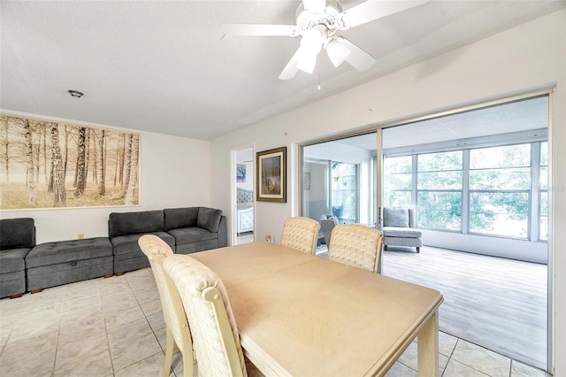 3840 Staysail Ln Unit 3840, Holiday, FL 34691 - dining area with light tile patterned floors, a ceiling fan, and a textured ceiling