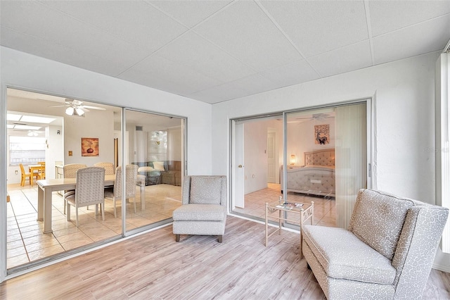 living area featuring hardwood / wood-style floors and ceiling fan