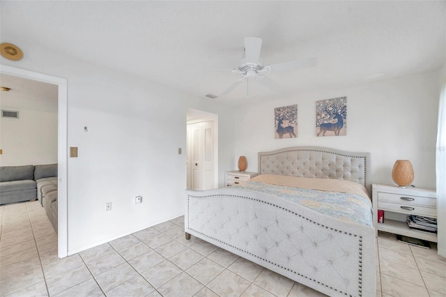 bedroom with ceiling fan, a closet, and light tile patterned flooring