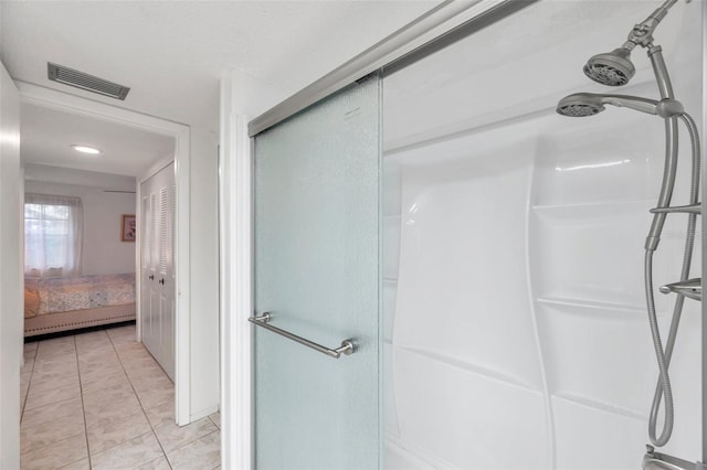 bathroom featuring a shower with shower door