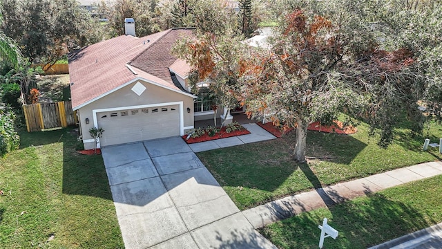 view of front of property featuring a front yard and a garage