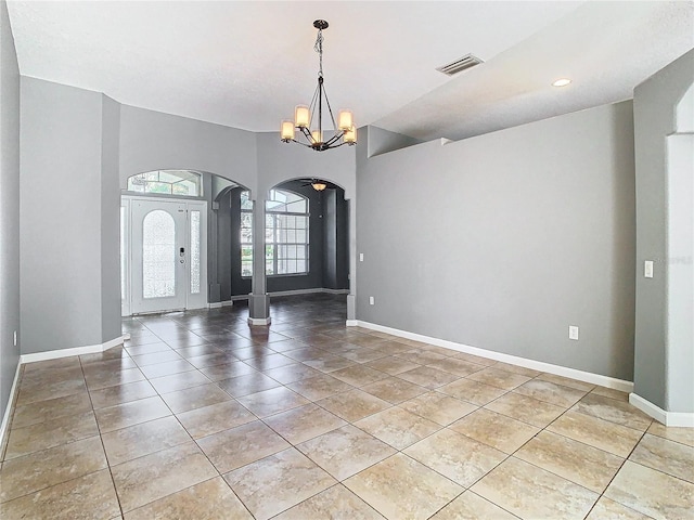 entryway with a chandelier and tile patterned flooring