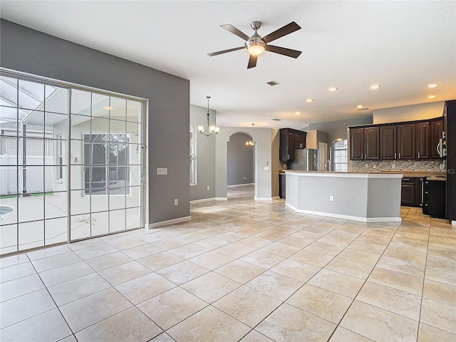 unfurnished living room featuring ceiling fan and light tile patterned floors