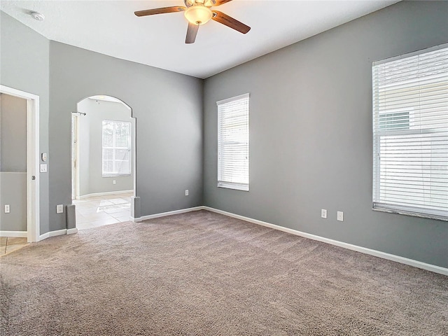 carpeted spare room with ceiling fan