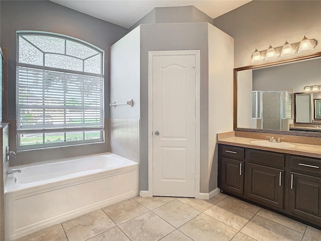 bathroom featuring vanity, tile patterned flooring, and plus walk in shower