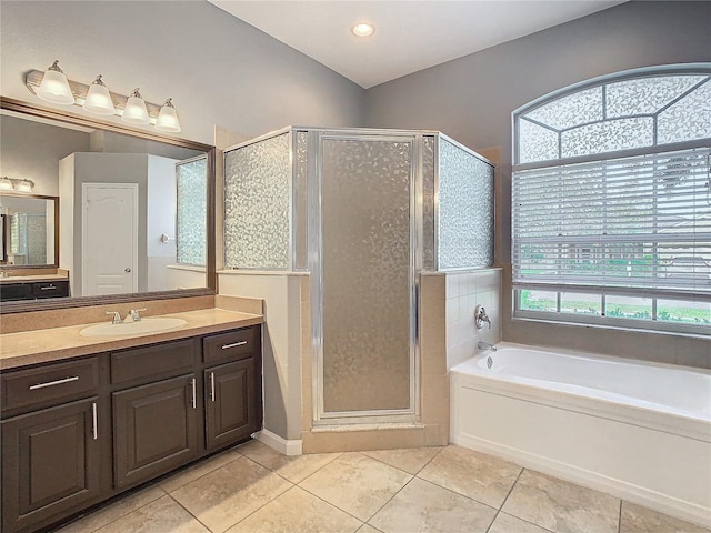 bathroom with vanity, tile patterned floors, and shower with separate bathtub