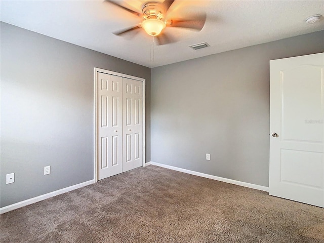 unfurnished bedroom featuring ceiling fan, carpet floors, and a closet