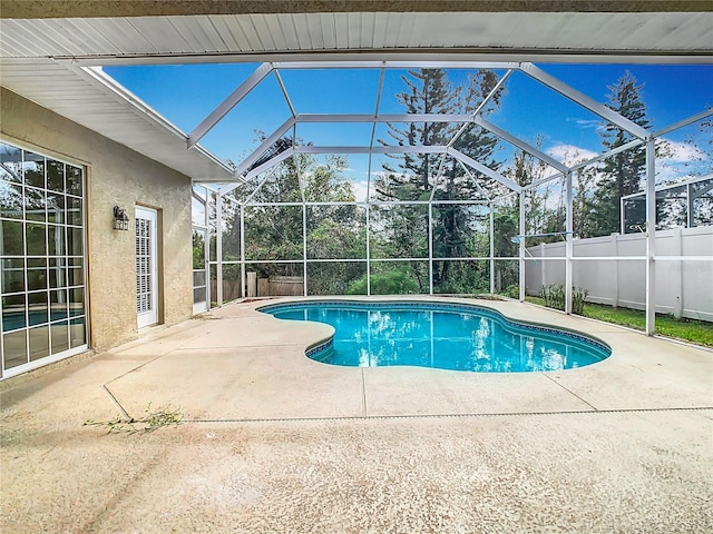 view of pool with a patio and a lanai